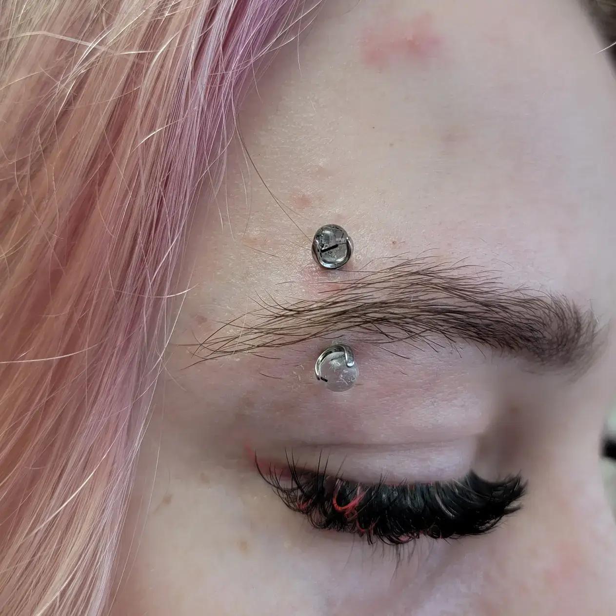 Eyebrow piercing done with implant grade titanium and genuine rutilated quartz