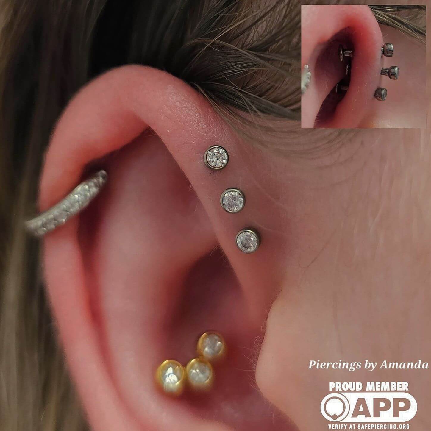 Triple forward helix piercings done by Amanda