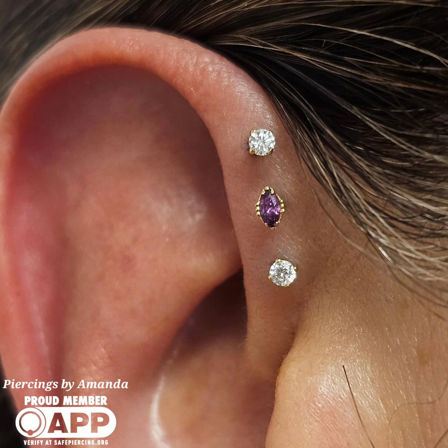 Set of triple forward helix piercings Amanda did with 18k gold